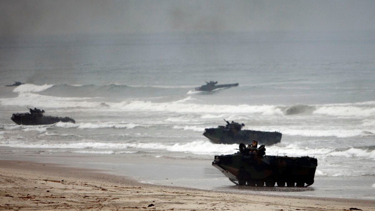 FILE - In this Friday, June 2, 2010 file photo, amphibious assault vehicles storm Red Beach...