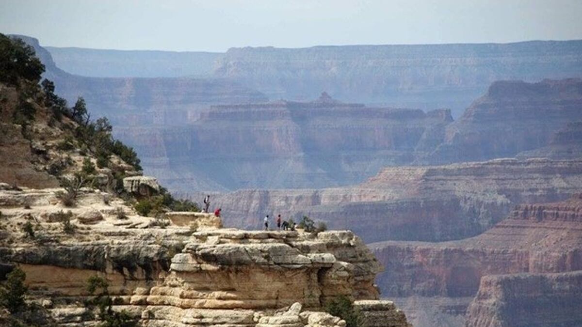 Visitors enjoy the view at the South Rim of the Grand Canyon.