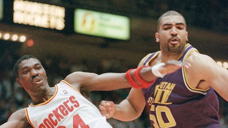 FILE - Houston Rockets' Hakeem Olajuwon (34), left, and Utah Jazz' Felton Spencer (50) react...