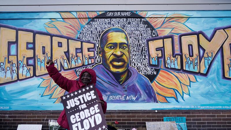 FILE - A person reacts near Cup Foods in Minneapolis after a guilty verdict was announced at...