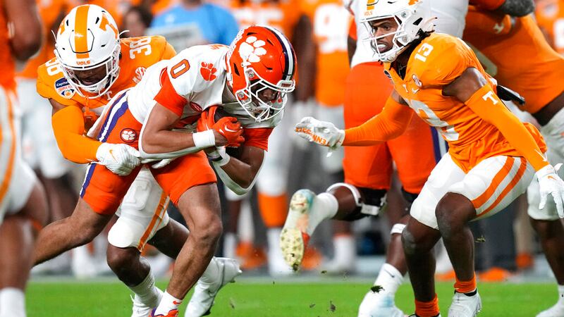 Clemson wide receiver Antonio Williams (0) runs as Tennessee linebacker Solon Page III (38)...