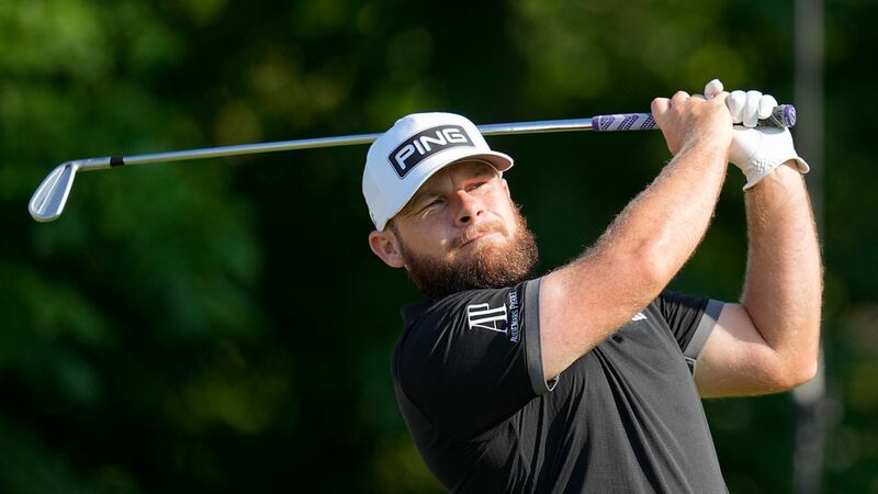 Tyrrell Hatton, of England, watches his tee shot on the 14th hole during the second round of...