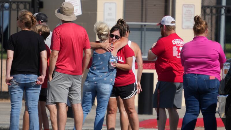 FILE - People gather for a community vigil at Tomball High School for the five members of an...