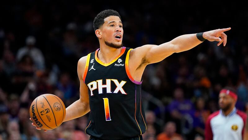 Phoenix Suns guard Devin Booker (1) calls a play during the first half of Game 3 of an NBA...
