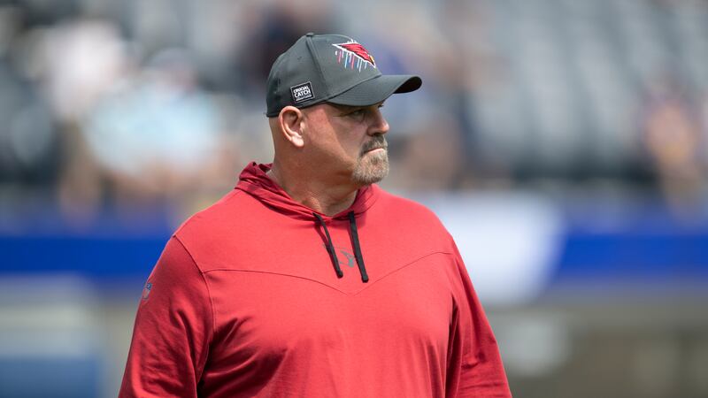 Arizona Cardinals offensive line coach Sean Kugler walks on the field before an NFL football...