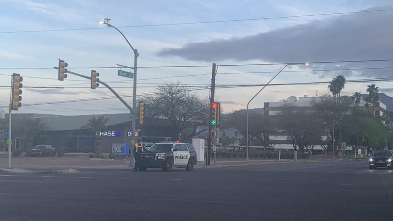Tucson police officers investigate a serious crash near the intersection of Broadway Boulevard...